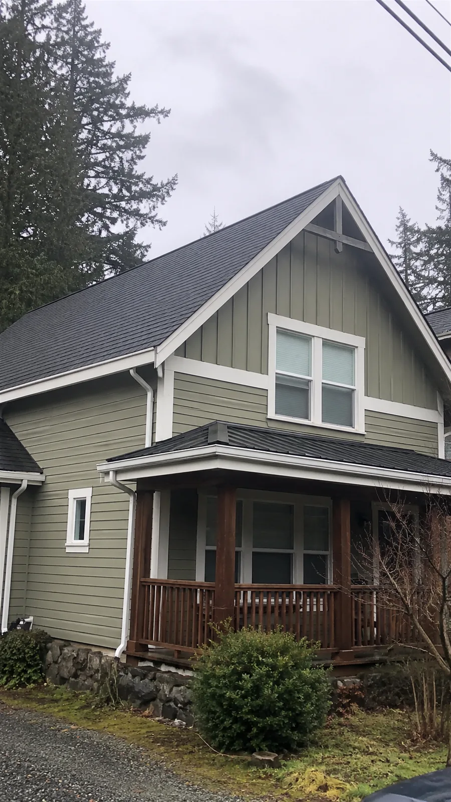 Steep roof and front porch after moss removal service